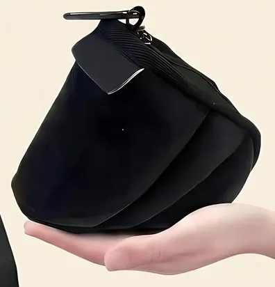 Travel sleep set packed into a compact black pouch held in one hand